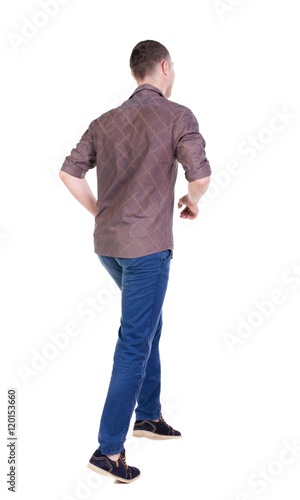 Back view of running man in brown shirt. Walking guy in motion. Rear view people collection. Backside view of person. Isolated over white background.