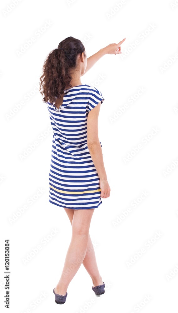 back view of woman. Young woman in vest presses down on something. Isolated over white background. Rear view people collection. backside view of person. she holds his hand open, palm forward. African back view of woman. Young woman in vest presses down on something. Isolated over white background. Rear view people collection. backside view of person. she holds his hand open, palm forward. African