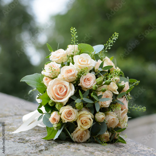 Bouquet of white roses close. Festive and wedding accessory. Romantic view of the flowers of the bride.