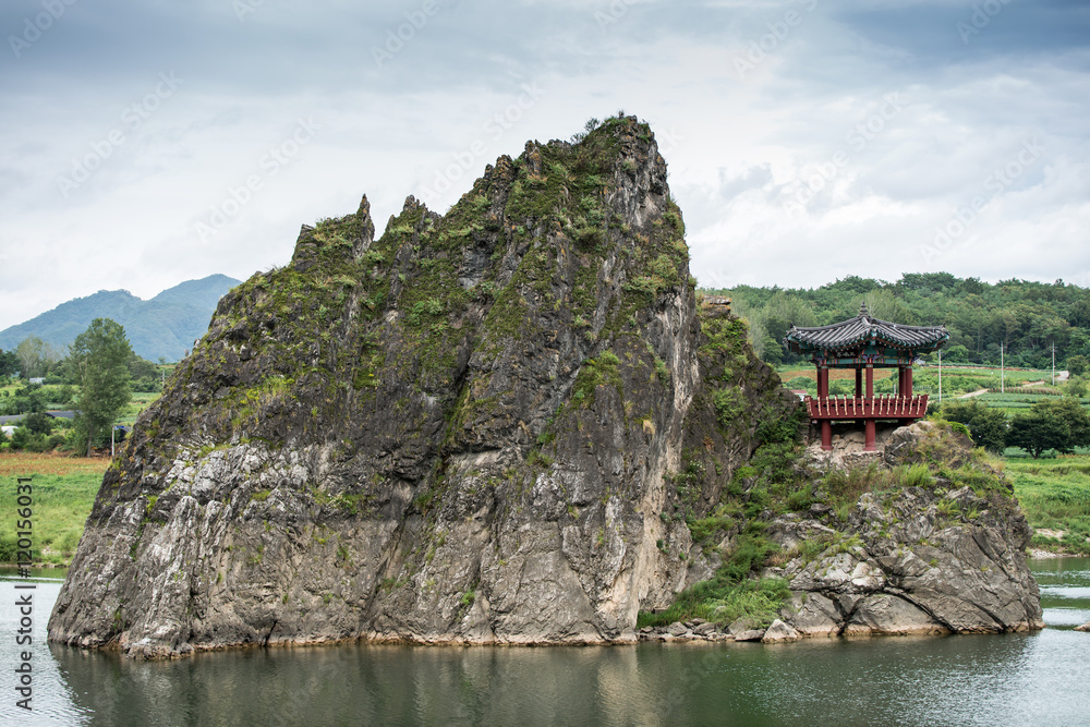 Chungcheongbuk-do, South Korea - August 29, 2016: Dodamsambong are three stone peaks rising out of the Namhangang River, South Korea Chungcheongbuk-do, South Korea - August 29, 2016: Dodamsambong are three stone peaks rising out of the Namhangang River, South Korea