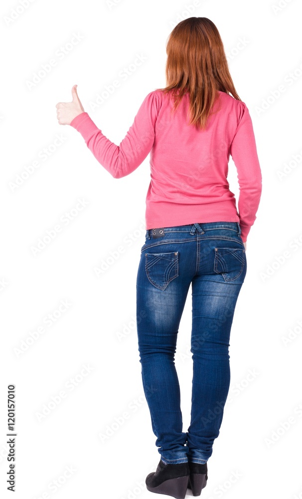 Back view of young beautiful woman going thumb up. Showing of positive emotions with OK sign concept . Rear view people collection. backside view of person. Isolated over white background. Back view of young beautiful woman going thumb up. Showing of positive emotions with OK sign concept . Rear view people collection. backside view of person. Isolated over white background.