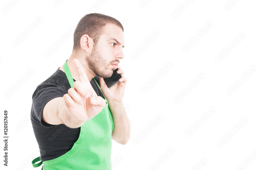 Supermarket seller making refuse gesture while phone speaking Supermarket seller making refuse gesture while phone speaking