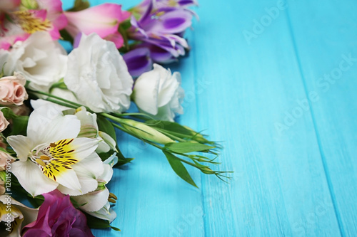 Fresh flowers on turquoise  wooden background