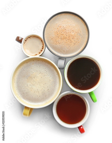 Cups of coffee on white background, top view