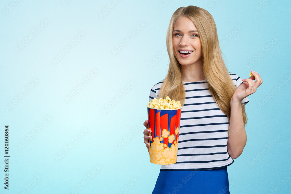 Beautiful girl eating popcorn on white background Beautiful girl eating popcorn on white background