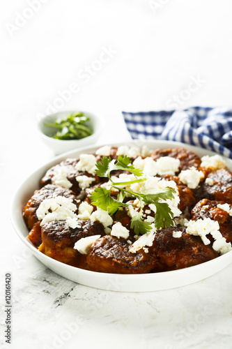 Meatballs in tomato sauce with feta cheese