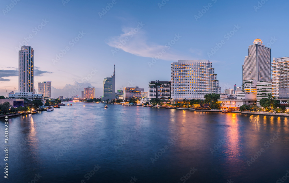 Bangkok city with business building and water traffic at chao pr
