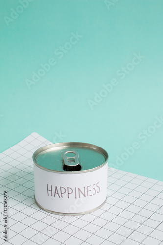 Happiness concept, The can of happiness  on blue background. Side light photo