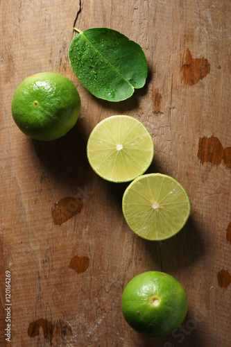 fresh limes on wooden background