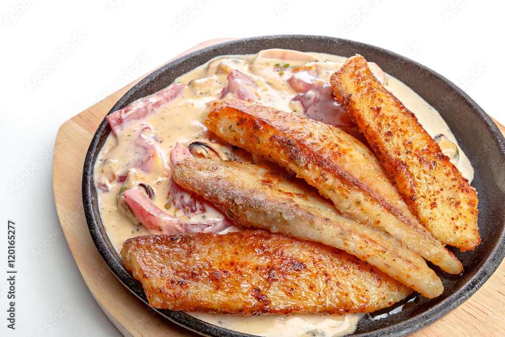 Baked fish  in a pan isolated on white