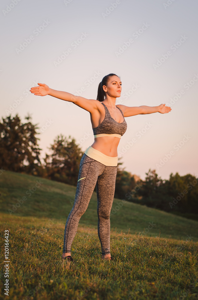 attractive young fitness woman practicing in the park. Sport con attractive young fitness woman practicing in the park. Sport con
