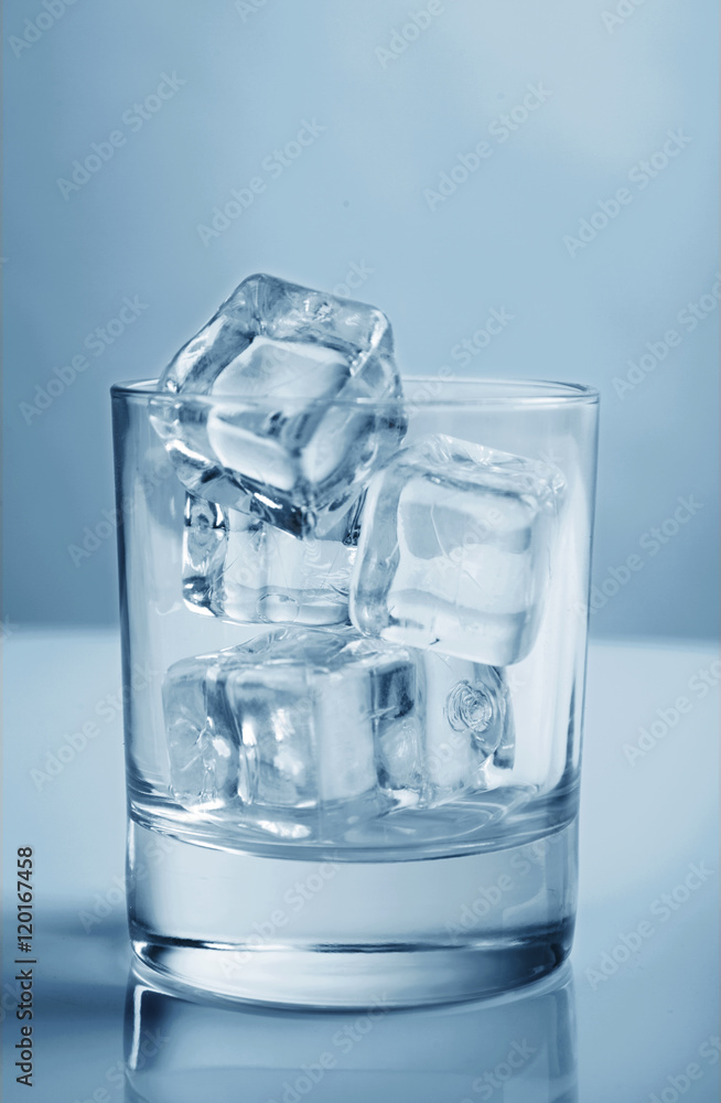Glass with ice cubes toning photo blue studio shot Glass with ice cubes toning photo blue studio shot