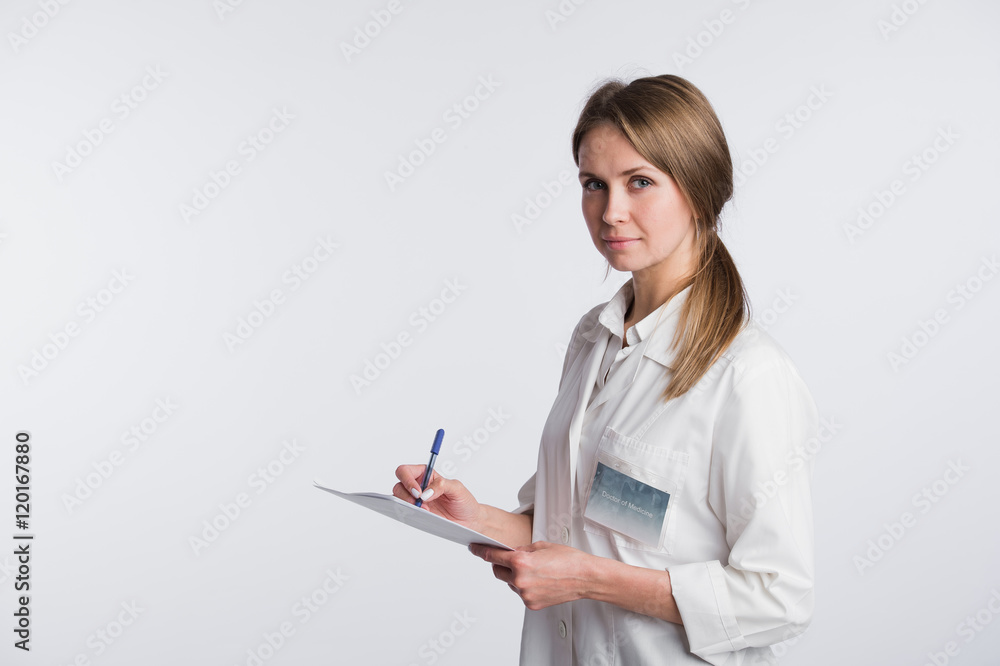 Cheerful medical doctor woman taking notes. Isolated on white Cheerful medical doctor woman taking notes. Isolated on white