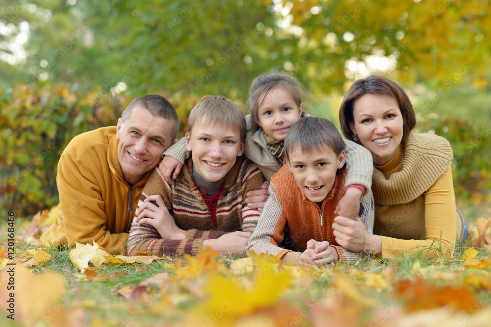 Family relaxing in autumn park