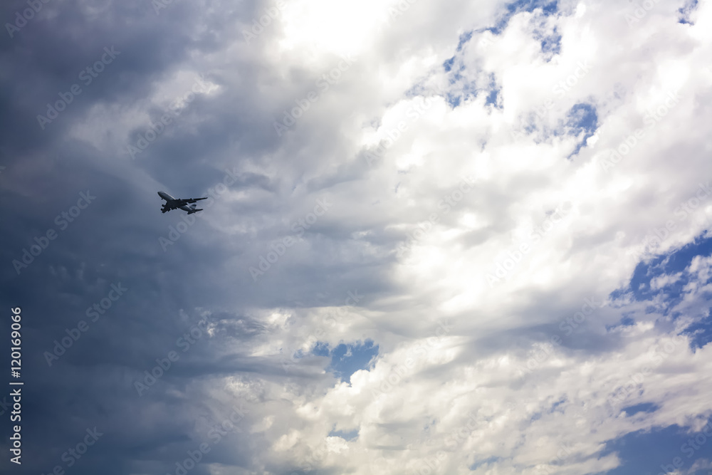 Jet approaching against a stormy sky