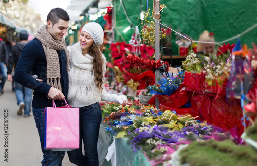 Couple buying Christmas flower at market © JackF