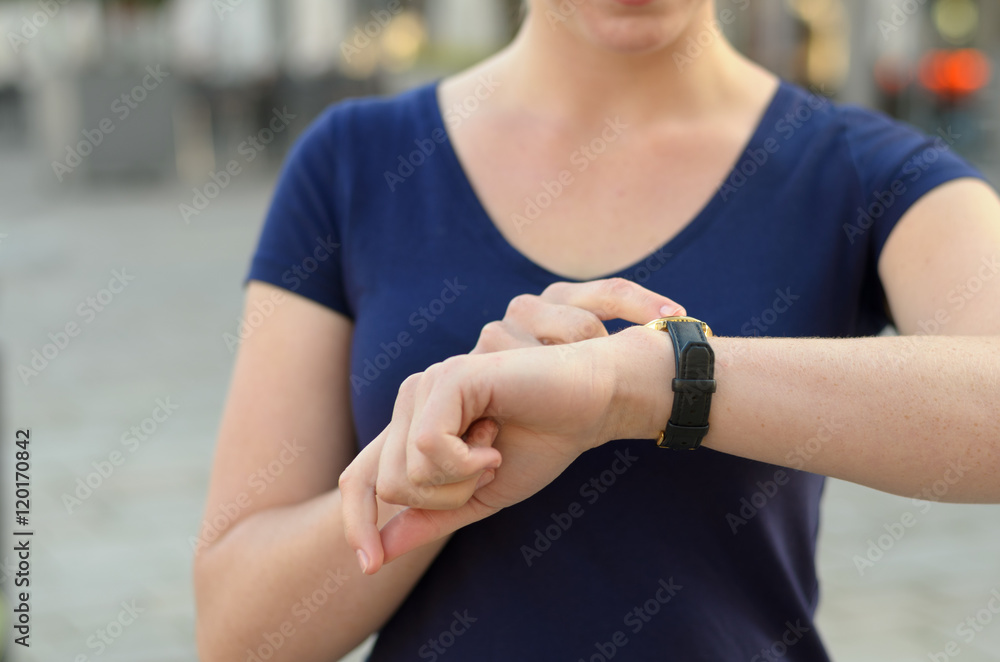 Woman checking the time on her smartwatch