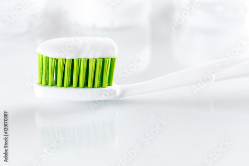 sqweezed green toothbrush on white background