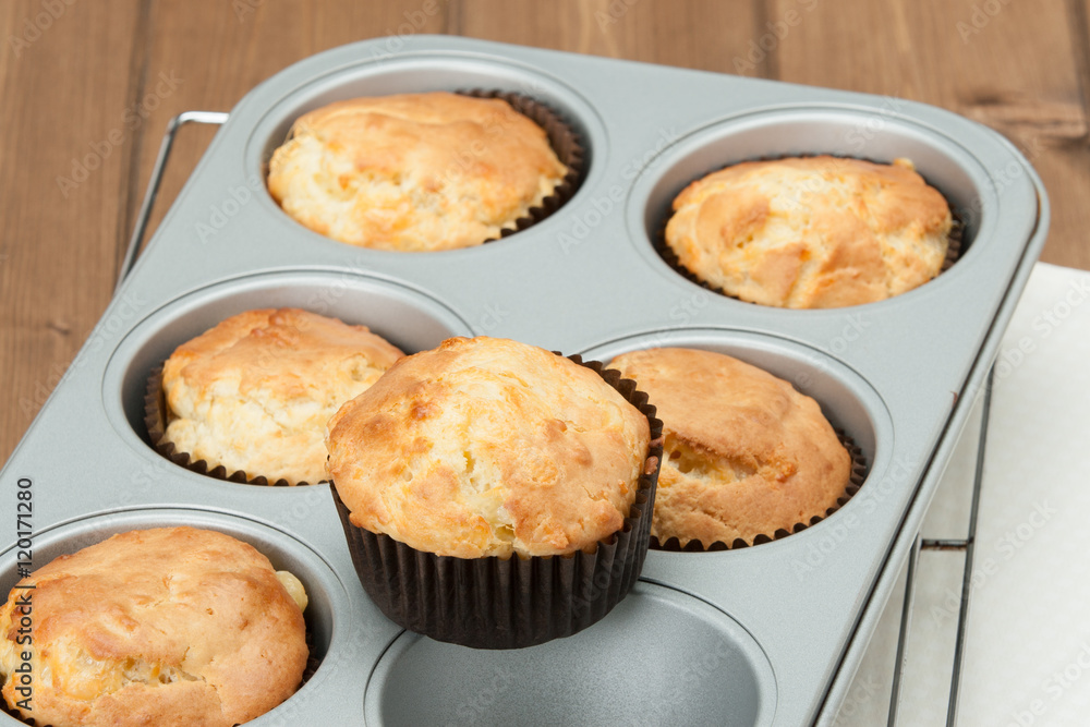 Homemade Cheddar Muffins In Baking Tray. Wooden Table. Homemade Cheddar Muffins In Baking Tray. Wooden Table.