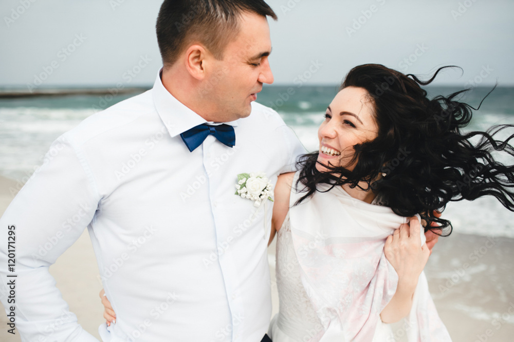 Lovely hugs of married couple on the beach Lovely hugs of married couple on the beach