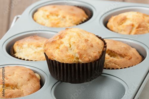 Homemade Cheddar Muffins In Baking Tray. Wooden Table.