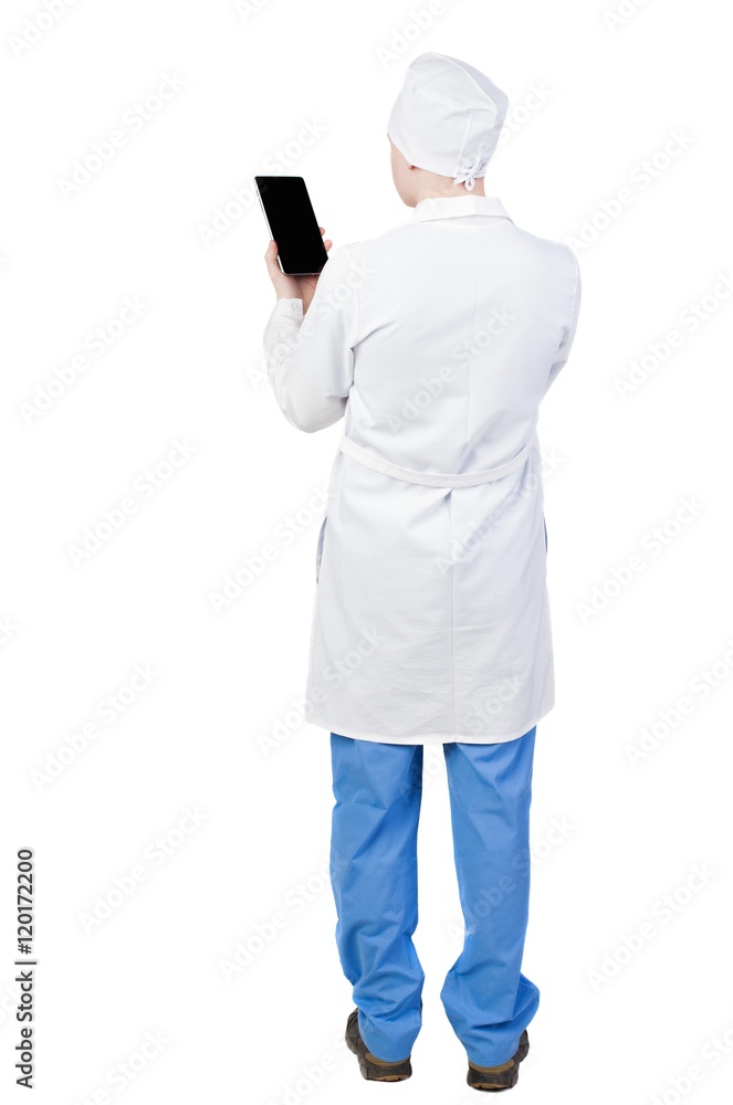 Back view of doctor in robe holding tablet computer. Standing young guy. Rear view people collection. backside view of person. Isolated over white background. Paramedic looks at the plate Back view of doctor in robe holding tablet computer. Standing young guy. Rear view people collection. backside view of person. Isolated over white background. Paramedic looks at the plate