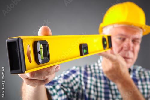 Portrait of senior constructor holding a ruler