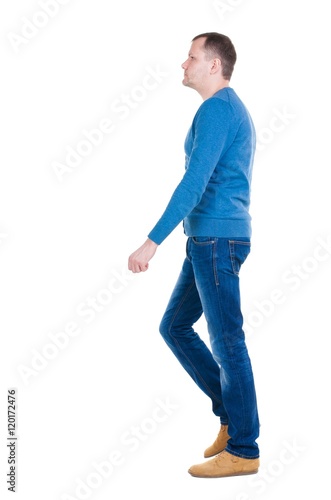 Back view of going handsome man in blue pullover. walking young guy . Rear view people collection. backside view of person. Isolated over white background.