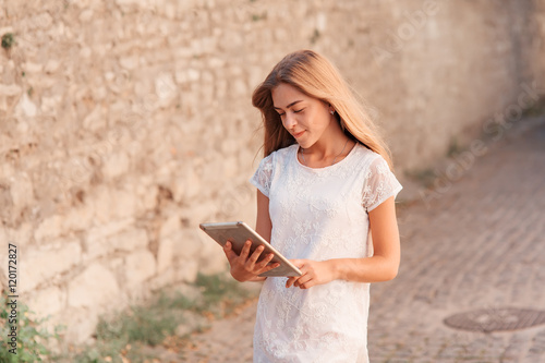 Elegant young woman using tablet © Aleksey