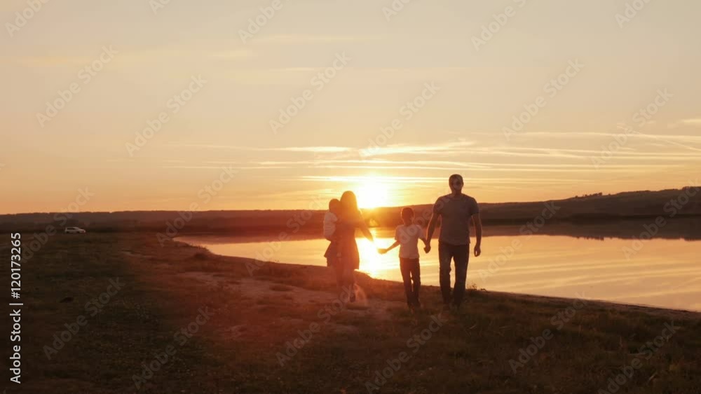 happy family at sunset silhouette of the water happy family at sunset silhouette of the water