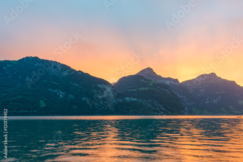 Sun set behind the mountain peaks in the Alps of Switzerland.