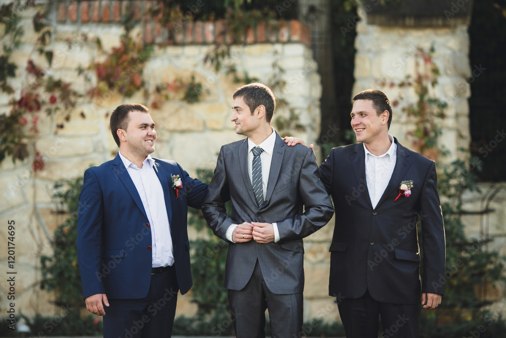 funny groom and his friends posing for camera funny groom and his friends posing for camera