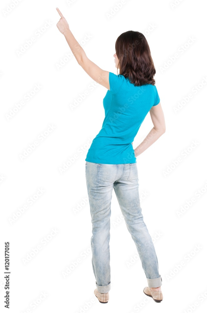 Back view of pointing woman. beautiful brunette girl in jeans. Rear view people collection. backside view of person. Isolated over white background. Back view of pointing woman. beautiful brunette girl in jeans. Rear view people collection. backside view of person. Isolated over white background.