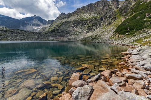 Stones in the water and reflection of Musalenski lakes,  Rila mountain, Bulgaria