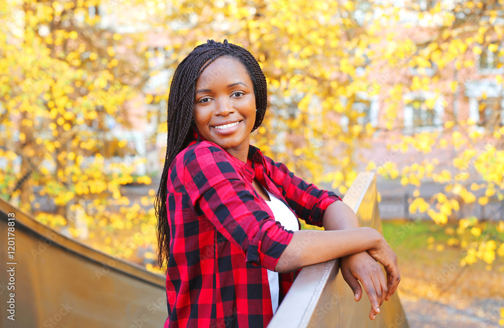 Portrait pretty smiling african woman wearing a red checkered sh Portrait pretty smiling african woman wearing a red checkered sh