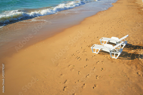 two loungers on the beach near the shore