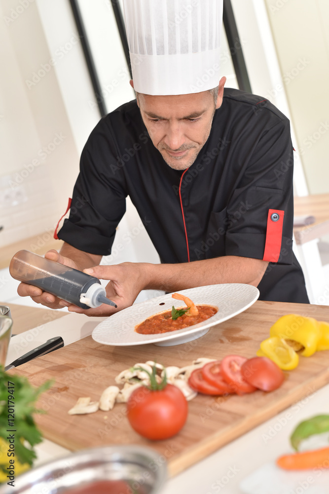 Chef finishing to prepare gourmet dish Chef finishing to prepare gourmet dish