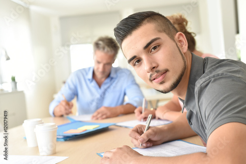 College students filling in registration forms