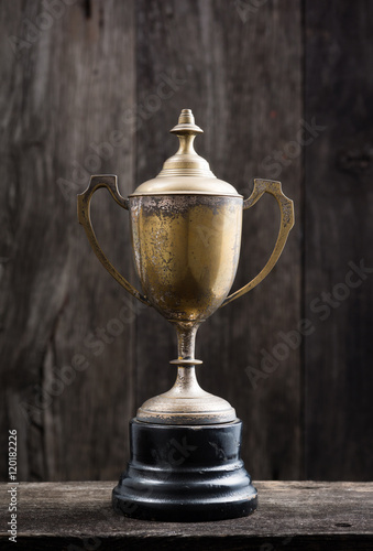 still life photography : old trophy on old wooden plank with space of old wood background