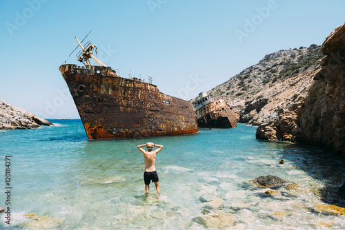 Greece, Cyclades Islands, Amorgos, Man at the beach, visiting a shipwreck, Olympia