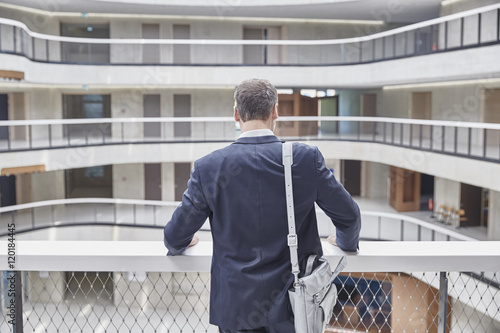 Businessman with bag in office building photo