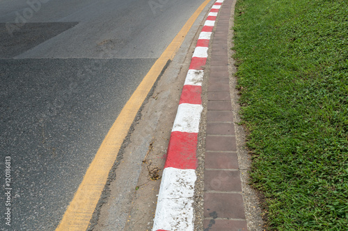 Red and white concrete road curb