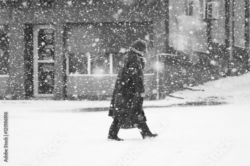 Snowing urban landscape with people passing by © ileana_bt