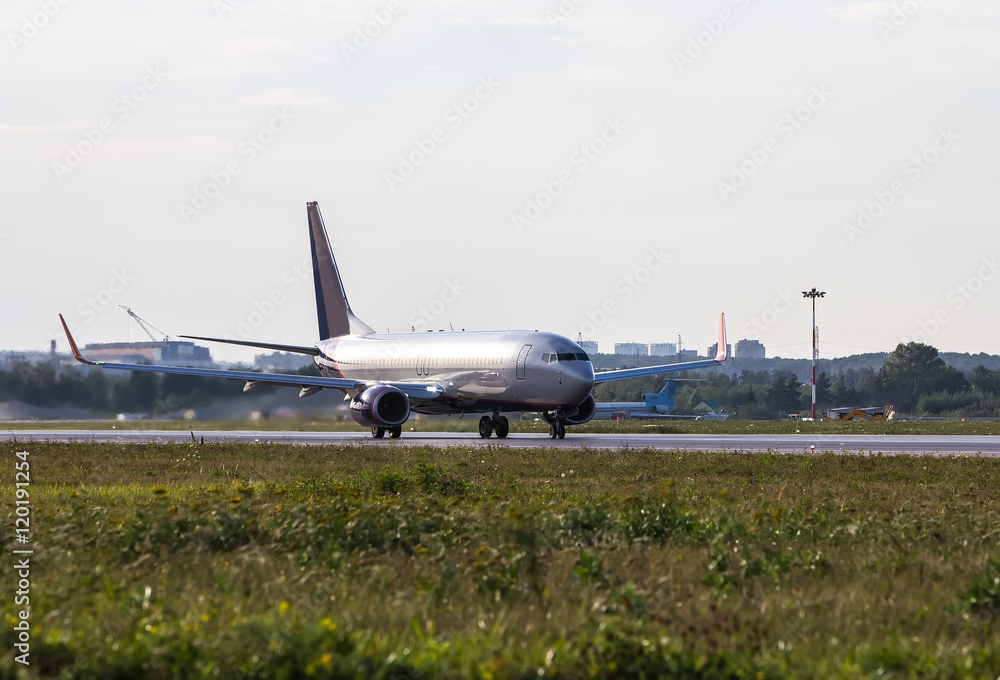 Fototapeta premium Big white passenger jet plane on runway at the airport