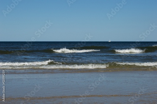 Sunny beach day with clear blue sky