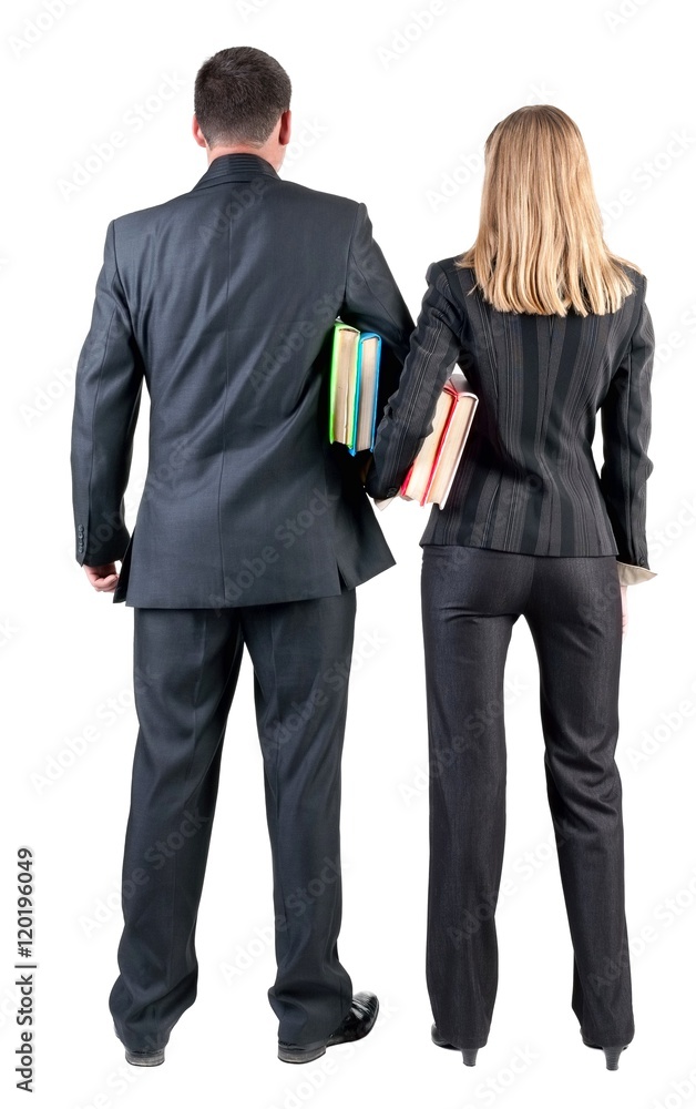 Back view of business team look into the distance. young couple (man and woman) with books. beautiful friendly girl and guy in suit together. Rear view people collection. backside view of person Back view of business team look into the distance. young couple (man and woman) with books. beautiful friendly girl and guy in suit together. Rear view people collection. backside view of person
