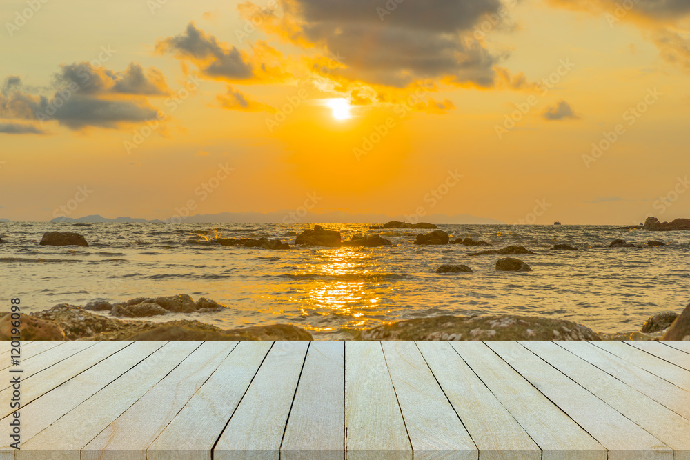 Empty wooden table or shelf wall with  sunset or sunrise on sand