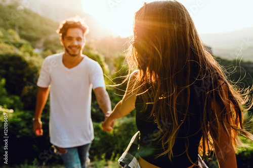 Quadro su tela Beautiful young couple enjoying nature at mountain peak.