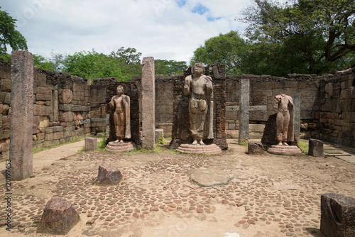 Ancient sculpture of standing Buddha, the ruins of the temple Hatadage photo