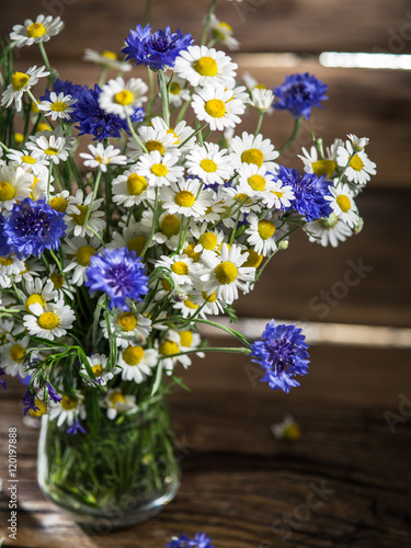 Wallpaper Mural Bouquet of chamomiles and cornflowers in the vase on the wooden Torontodigital.ca